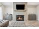 Living room featuring fireplace and TV above; matching cabinets on either side and large ottoman with gray L-shaped sofa at 2048 Violet Lane, Brookhaven, GA 30319