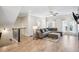 Upstairs living room features a large sofa, fireplace, mounted TV, lots of light, and view of the staircase at 2048 Violet Lane, Brookhaven, GA 30319