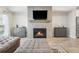 Spacious living room featuring a fireplace with mounted TV and matching cabinets on either side for ample storage space at 2048 Violet Lane, Brookhaven, GA 30319