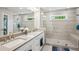 Beautiful bathroom featuring double sinks and a large walk-in glass shower with bench at 2048 Violet Lane, Brookhaven, GA 30319