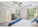 Bright main bedroom with tray ceiling, dual windows, and ensuite bathroom at 2048 Violet Lane, Brookhaven, GA 30319