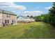 Generous backyard space with healthy green grass and a view of the neighboring townhomes at 2051 Wildflower Way, Conyers, GA 30012