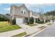 Exterior view of a townhome with a one-car garage and well-maintained landscaping at 2051 Wildflower Way, Conyers, GA 30012