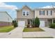 Inviting townhome exterior with a one-car garage, tidy lawn, and welcoming entrance at 2051 Wildflower Way, Conyers, GA 30012