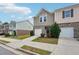 Charming townhome with a one-car garage, landscaped yard, and inviting front entrance at 2051 Wildflower Way, Conyers, GA 30012