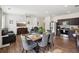 Open-concept living and dining area with modern furnishings and stainless steel appliances at 2051 Wildflower Way, Conyers, GA 30012
