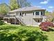 Backyard view of the house showing its siding, deck, stairs, and beautiful landscaping at 434 Meadowfield Ct, Lawrenceville, GA 30043
