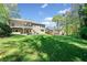 Large, green backyard with a wooden deck, perfect for outdoor activities at 434 Meadowfield Ct, Lawrenceville, GA 30043