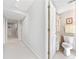 Bright hallway bathroom with light tile, matching floral shower curtain and plenty of natural light at 434 Meadowfield Ct, Lawrenceville, GA 30043