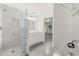 Modern bathroom featuring marble walls, glass shower, and a bright, white vanity at 831 Mercury Nw Dr, Atlanta, GA 30331