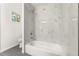 Modern bathroom featuring bathtub with tiled walls and grey tile flooring at 831 Mercury Nw Dr, Atlanta, GA 30331