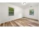 Bright bedroom features two windows and luxury vinyl plank flooring at 831 Mercury Nw Dr, Atlanta, GA 30331