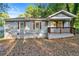 Charming single-story home with a cozy front porch and traditional wood shutters at 831 Mercury Nw Dr, Atlanta, GA 30331