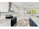Bright kitchen featuring stainless steel appliances, white cabinets, and granite countertops at 831 Mercury Nw Dr, Atlanta, GA 30331