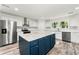 Bright kitchen featuring stainless steel appliances, white cabinets, and center island at 831 Mercury Nw Dr, Atlanta, GA 30331