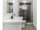 Sleek bathroom with modern vanity, glass-enclosed shower, contemporary fixtures, and stylish tile accents at 1318 Graymont Sw Dr, Atlanta, GA 30310