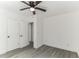 Bright bedroom with neutral walls, vinyl floors, ceiling fan, and double-door closet at 1318 Graymont Sw Dr, Atlanta, GA 30310