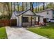 Charming renovated cottage home featuring a freshly painted exterior, inviting porch, and well-manicured front yard at 1318 Graymont Sw Dr, Atlanta, GA 30310