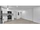 Open-concept kitchen with stainless steel appliances, sleek white cabinets, and an adjacent living area at 1318 Graymont Sw Dr, Atlanta, GA 30310