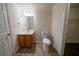 Cozy bathroom featuring tile floors, a vanity with sink, mirror, and a toilet at 2899 Duncan Pl, Decatur, GA 30034