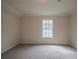 This bedroom has neutral carpet and a large window at 2899 Duncan Pl, Decatur, GA 30034