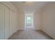 Bedroom featuring neutral carpet, window, and closet providing ample storage space at 2899 Duncan Pl, Decatur, GA 30034