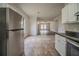 Open kitchen view into living area, featuring stainless steel refrigerator and granite counters at 2899 Duncan Pl, Decatur, GA 30034