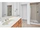 Bathroom with a large mirror, wooden vanity, and a glass-enclosed shower at 5480 Beaver Ridge Drive Dr, Cumming, GA 30040