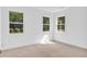 Bright bedroom with neutral carpet and three windows offering natural light at 5480 Beaver Ridge Drive Dr, Cumming, GA 30040