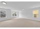 Bright bonus room with neutral walls, carpet, and windows offering neighborhood views at 5480 Beaver Ridge Drive Dr, Cumming, GA 30040