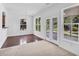Bright dining room with hardwood floors, large windows, and sliding glass doors to outdoor space at 5480 Beaver Ridge Drive Dr, Cumming, GA 30040