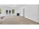 Spacious living room with a modern fireplace, carpeted floors, and doors leading to the outside at 5480 Beaver Ridge Drive Dr, Cumming, GA 30040