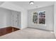 Bright living room featuring carpeted floors, large windows, and decorative molding at 5480 Beaver Ridge Drive Dr, Cumming, GA 30040