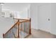 Upstairs landing with a wooden staircase, iron balusters, and white doors at 5480 Beaver Ridge Drive Dr, Cumming, GA 30040