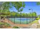Well-maintained tennis court with a green surround, perfect for recreational play at 5480 Beaver Ridge Drive Dr, Cumming, GA 30040