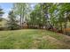 Expansive backyard with lush green grass and mature trees at 5628 Fallsbrook Nw Knl, Acworth, GA 30101
