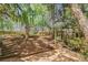 Multi-level backyard featuring a deck, fire pit, and lush landscaping at 5628 Fallsbrook Nw Knl, Acworth, GA 30101