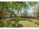 Expansive backyard with mature trees and wooden privacy fence at 5628 Fallsbrook Nw Knl, Acworth, GA 30101