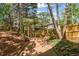 Beautiful backyard featuring a wooden walkway, lush greenery, and a charming pergola with space for gardening at 5628 Fallsbrook Nw Knl, Acworth, GA 30101