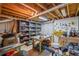 Spacious basement with exposed ceiling, storage shelves, and workbench area at 5628 Fallsbrook Nw Knl, Acworth, GA 30101