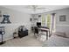 Comfortable bedroom featuring natural light, a ceiling fan, and a dedicated workspace for studying or remote work at 5628 Fallsbrook Nw Knl, Acworth, GA 30101