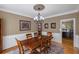 Formal dining room featuring elegant chandelier, decorative rug, and classic wainscoting at 5628 Fallsbrook Nw Knl, Acworth, GA 30101