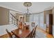 Elegant dining room with chandelier, hardwood floors, and views to the entry and staircase at 5628 Fallsbrook Nw Knl, Acworth, GA 30101
