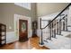 Bright entryway with hardwood floors, a grand staircase, and a decorative front door at 5628 Fallsbrook Nw Knl, Acworth, GA 30101