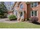 Brick home with arched entry, two-car garage and a neatly landscaped front lawn at 5628 Fallsbrook Nw Knl, Acworth, GA 30101