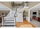 Elegant two-story foyer featuring hardwood floors, a staircase with black railings, and a coat rack at 5628 Fallsbrook Nw Knl, Acworth, GA 30101