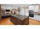 Open kitchen layout with a large island, stainless steel appliances, and hardwood floors at 5628 Fallsbrook Nw Knl, Acworth, GA 30101