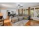 Bright living room featuring hardwood floors, a comfortable sectional, and seamless kitchen access at 5628 Fallsbrook Nw Knl, Acworth, GA 30101