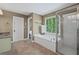 Bright main bathroom with separate shower, soaking tub, and tiled floors at 5628 Fallsbrook Nw Knl, Acworth, GA 30101