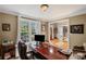 Inviting home office with natural light, a spacious desk, and views of the entryway at 5628 Fallsbrook Nw Knl, Acworth, GA 30101